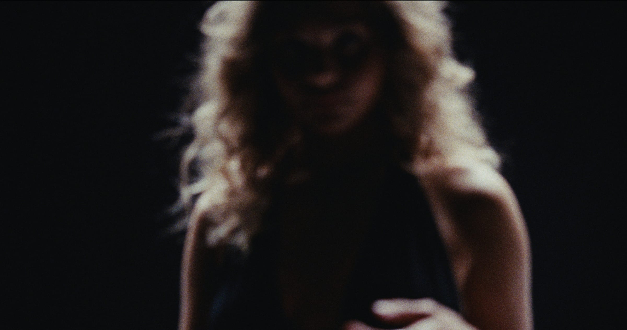 A dark stage figure